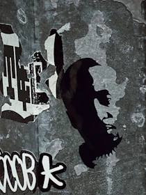 Urban street scene in Mexico City with a weathered poster featuring coffee notes pinned on a cracked wall.