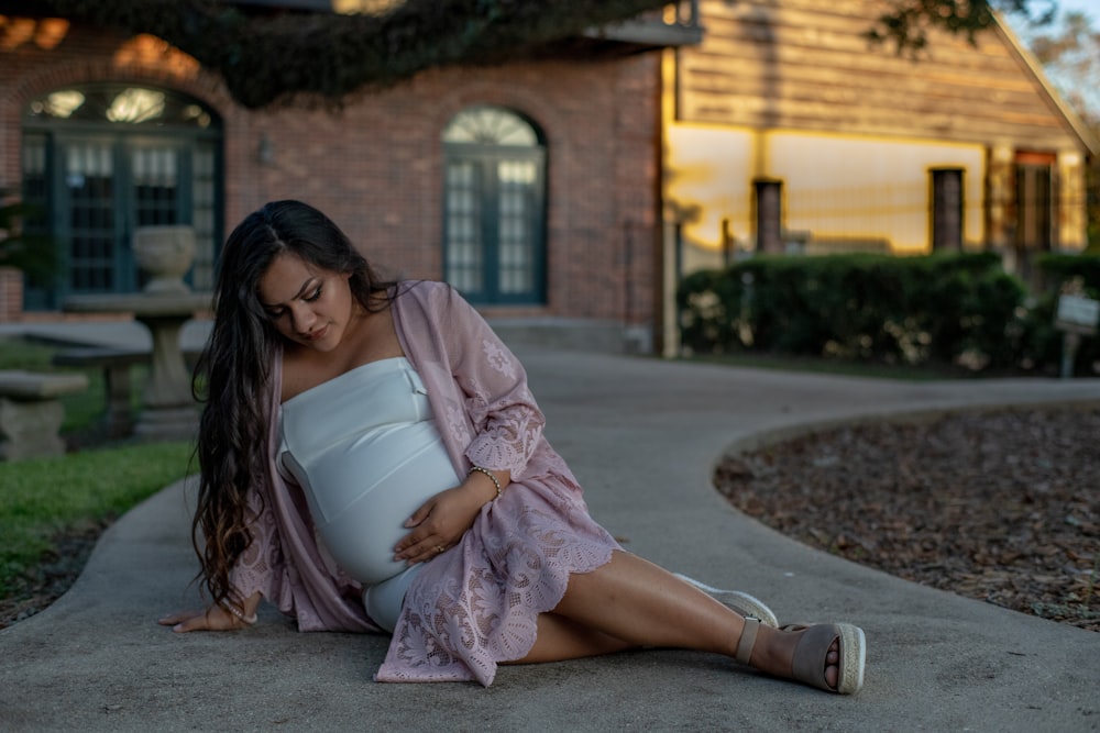 woman sits on pathway