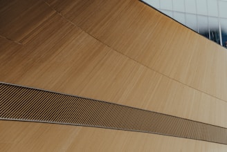 A modern wooden art piece that complements contemporary architecture.