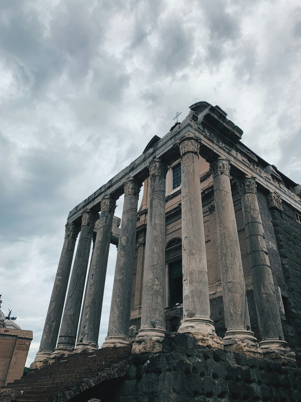 low-angle photography of a gray concrete building ruins