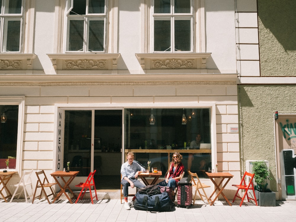 two people sitting on chair beside store