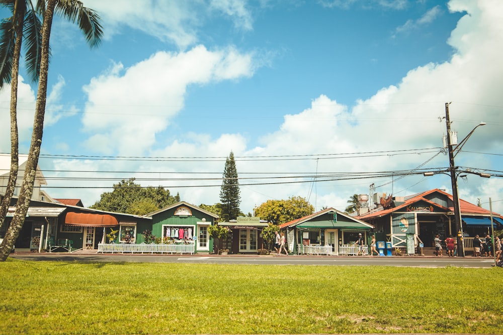 landscape photography of houses under a cloudy sky during daytime