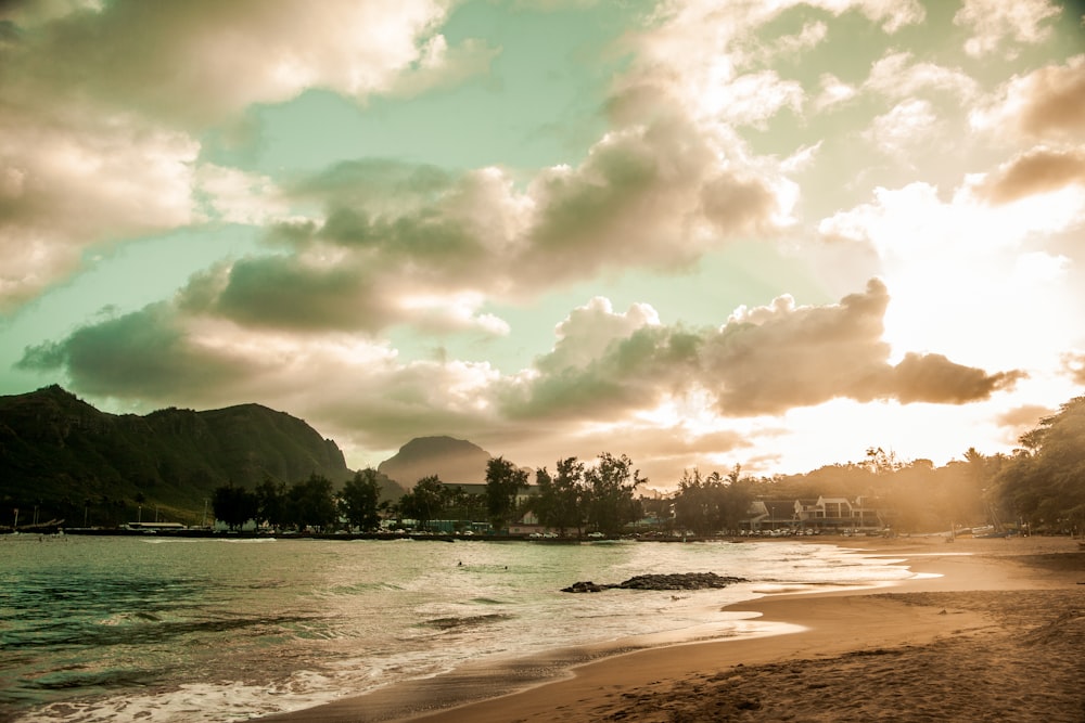 waves splashing by the seashore under a cloudy sky during golden hour