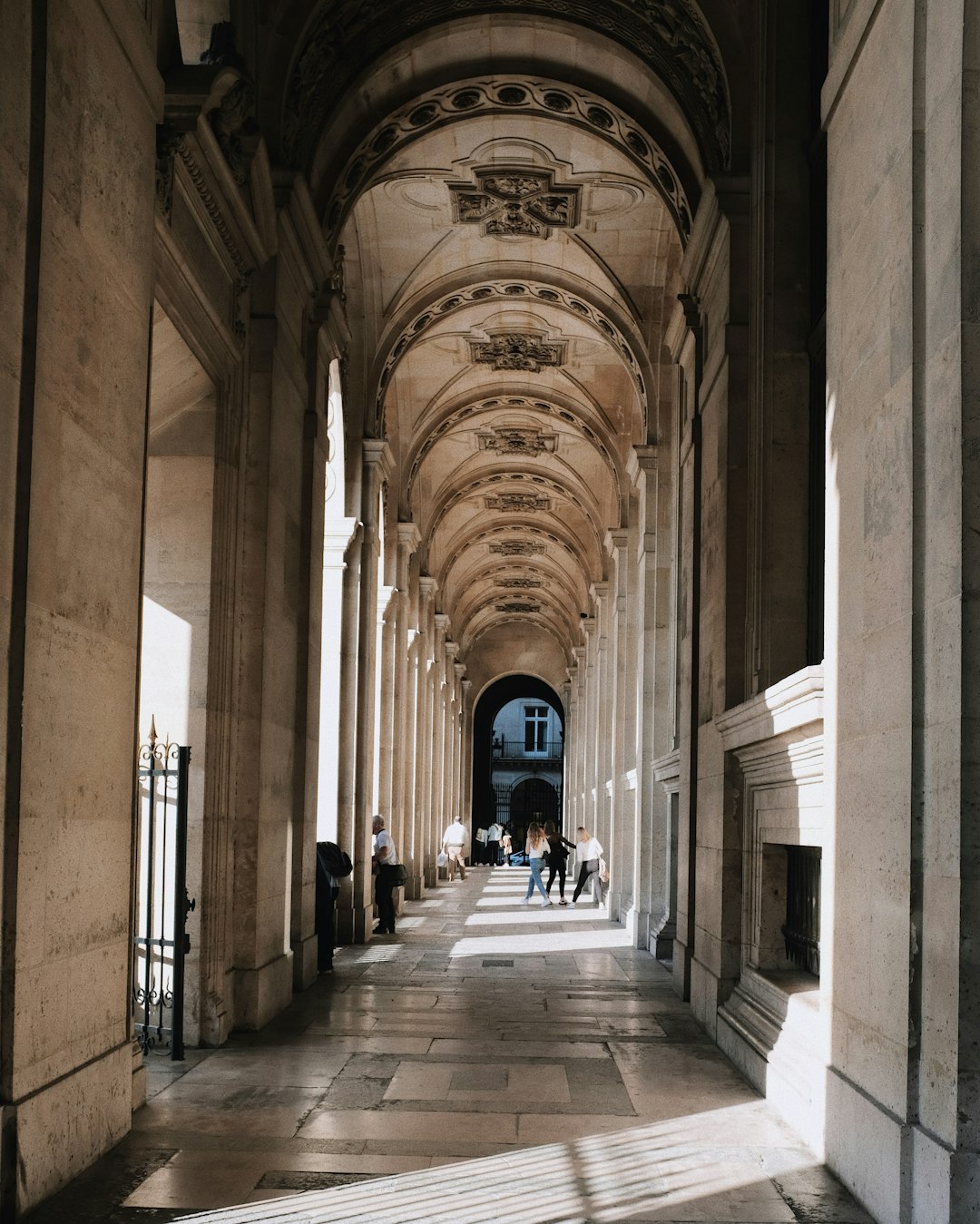 people walking along the hallway of a building