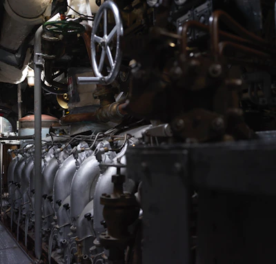 High-precision Emerson Fisher control valve installed on a large pipeline surrounded by industrial machinery