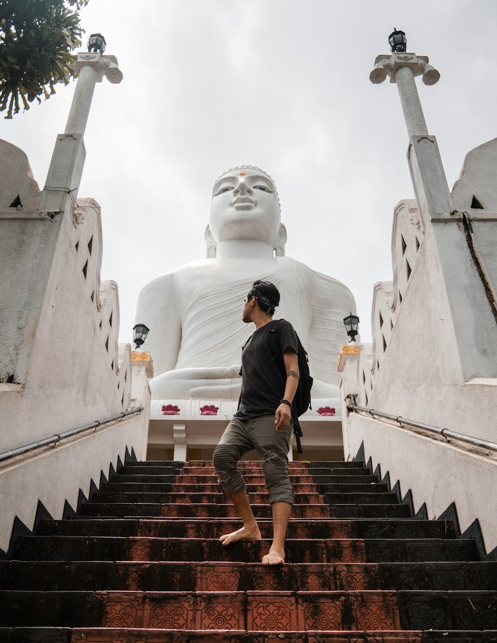 man wearing black shirt standing on stair