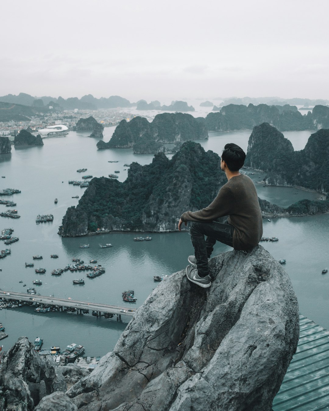 man sitting on cliff