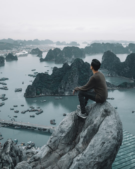 man sitting on cliff in Poem Mountain Vietnam