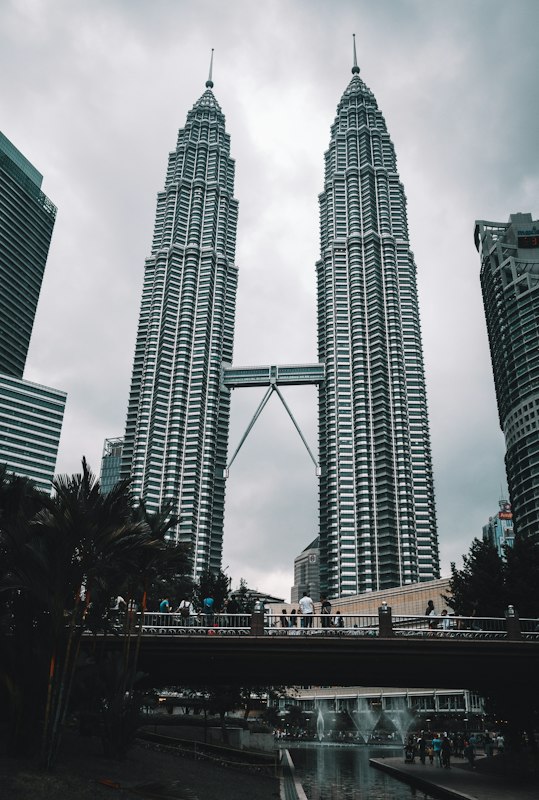 Couple at rooftop pool with Petronas Towers view