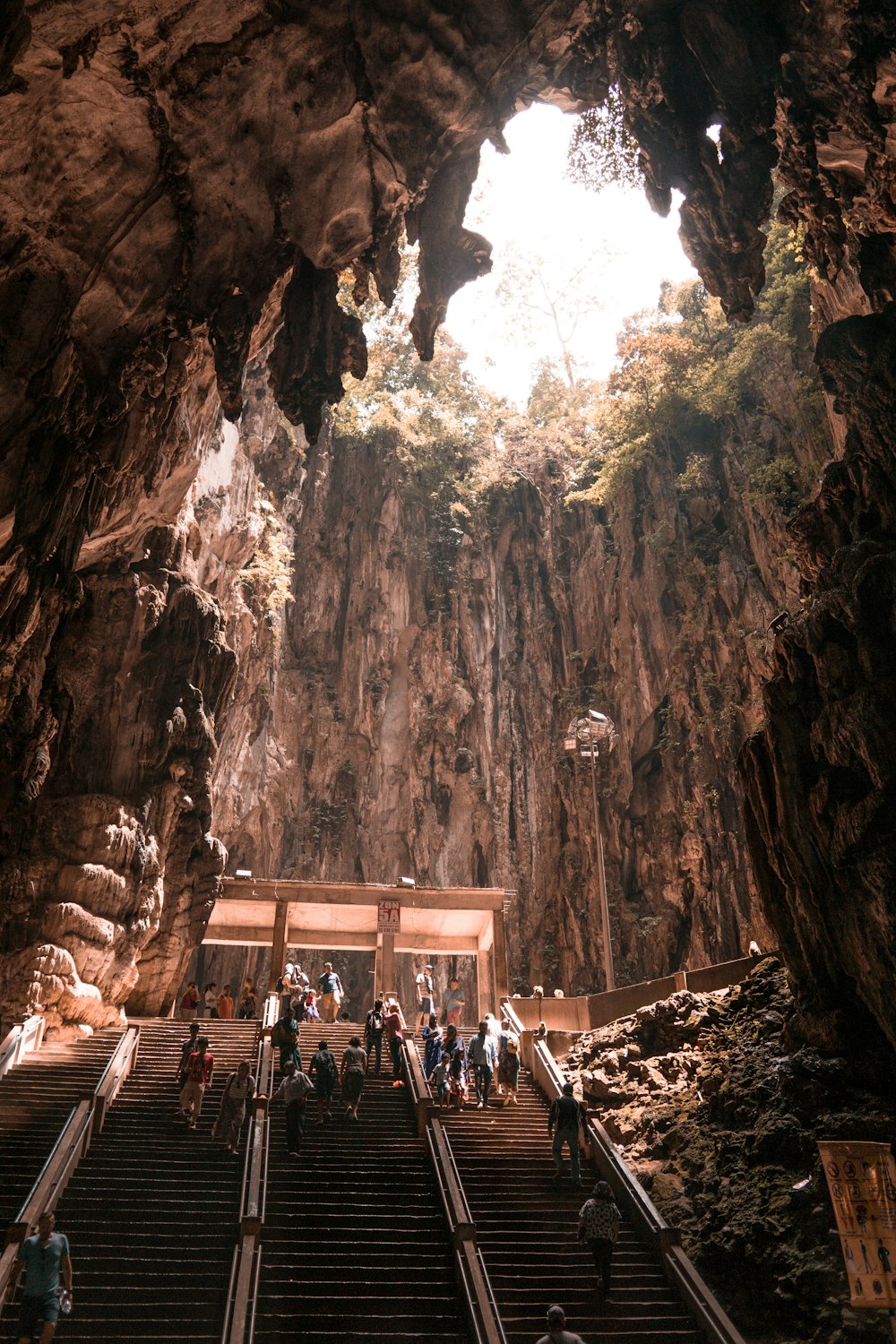 people at the stairs inside cave