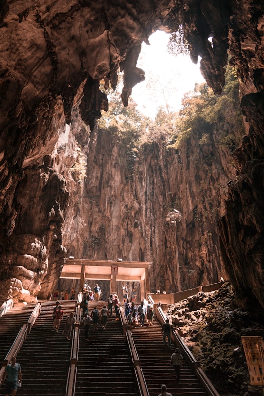 people at the stairs inside cave in Batu Caves Malaysia