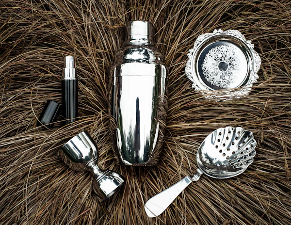 Close-up of a premium bar tool set arranged neatly on a crisp white surface, highlighting the fine craftsmanship.