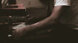 Close-up of hands engaged in mindful writing under soft light.