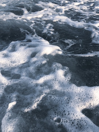 Foamy seawater with waves and bubbles, capturing the movement and texture of the ocean's surface