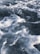 Foamy seawater with waves and bubbles, capturing the movement and texture of the ocean's surface
