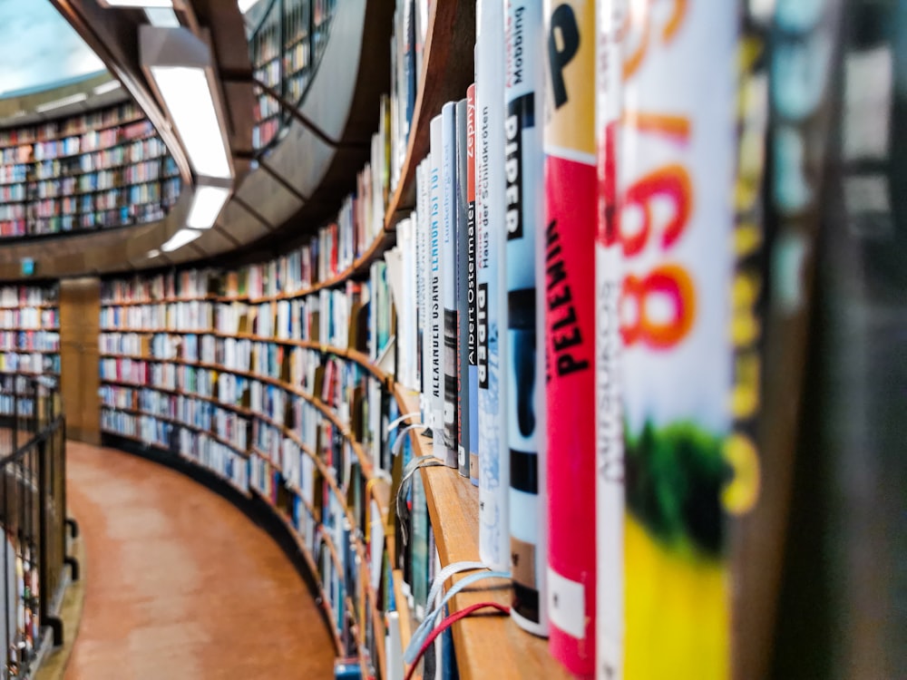 a library filled with lots of books next to a staircase