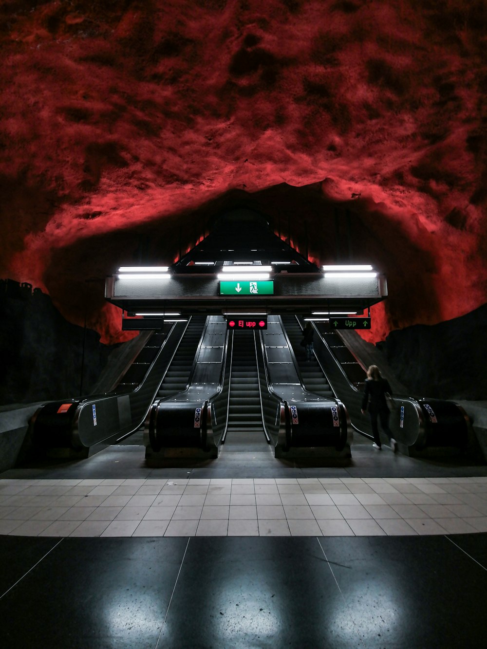 person riding escalator