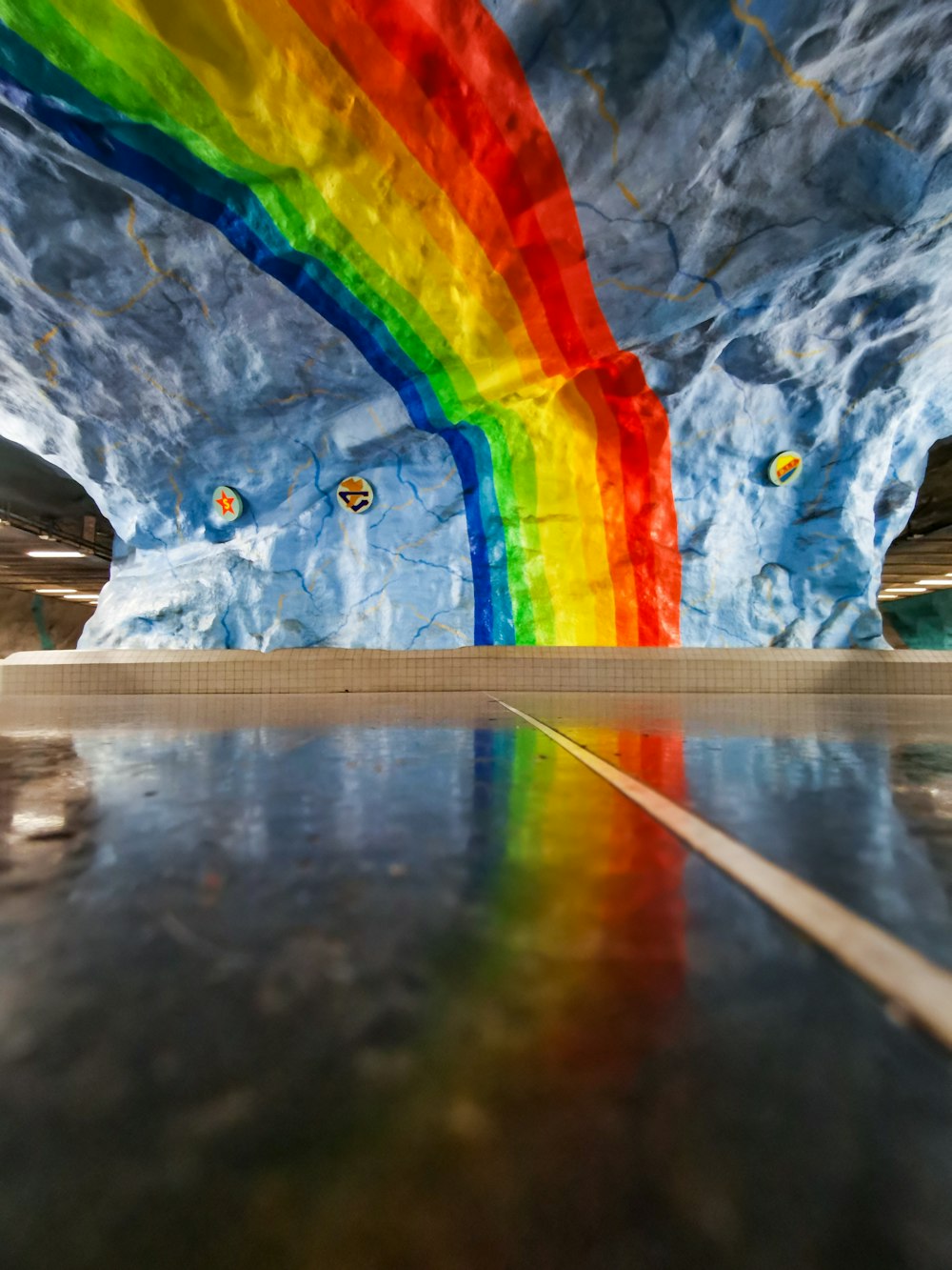 a rainbow painted on the side of a building