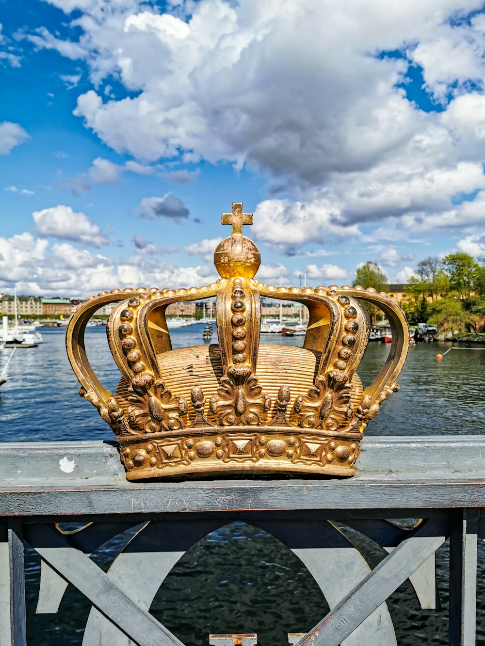 gold crown with a cumulus clouds in the background