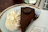 A happy customer enjoying a slice of chocolate cake at Sweet Haven Bakery.