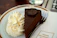 A happy customer enjoying a slice of chocolate cake at Sweet Haven Bakery.