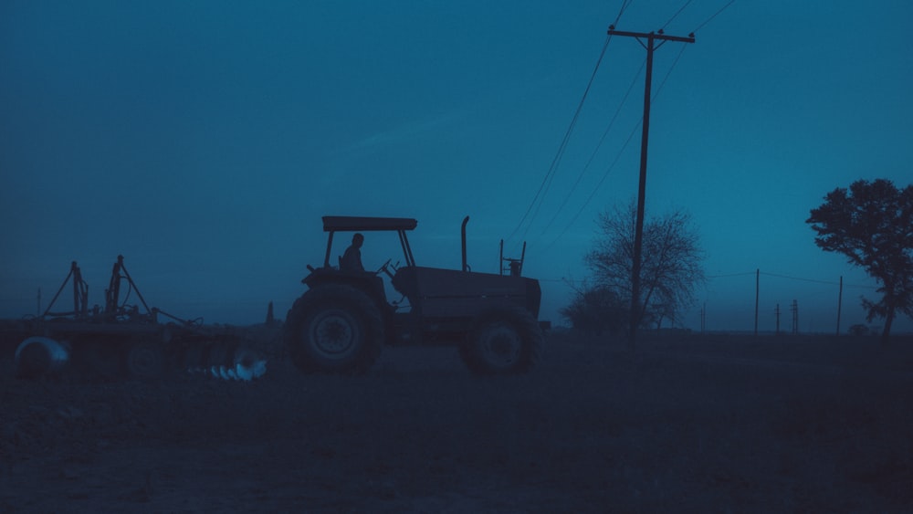 a tractor parked in a field at night
