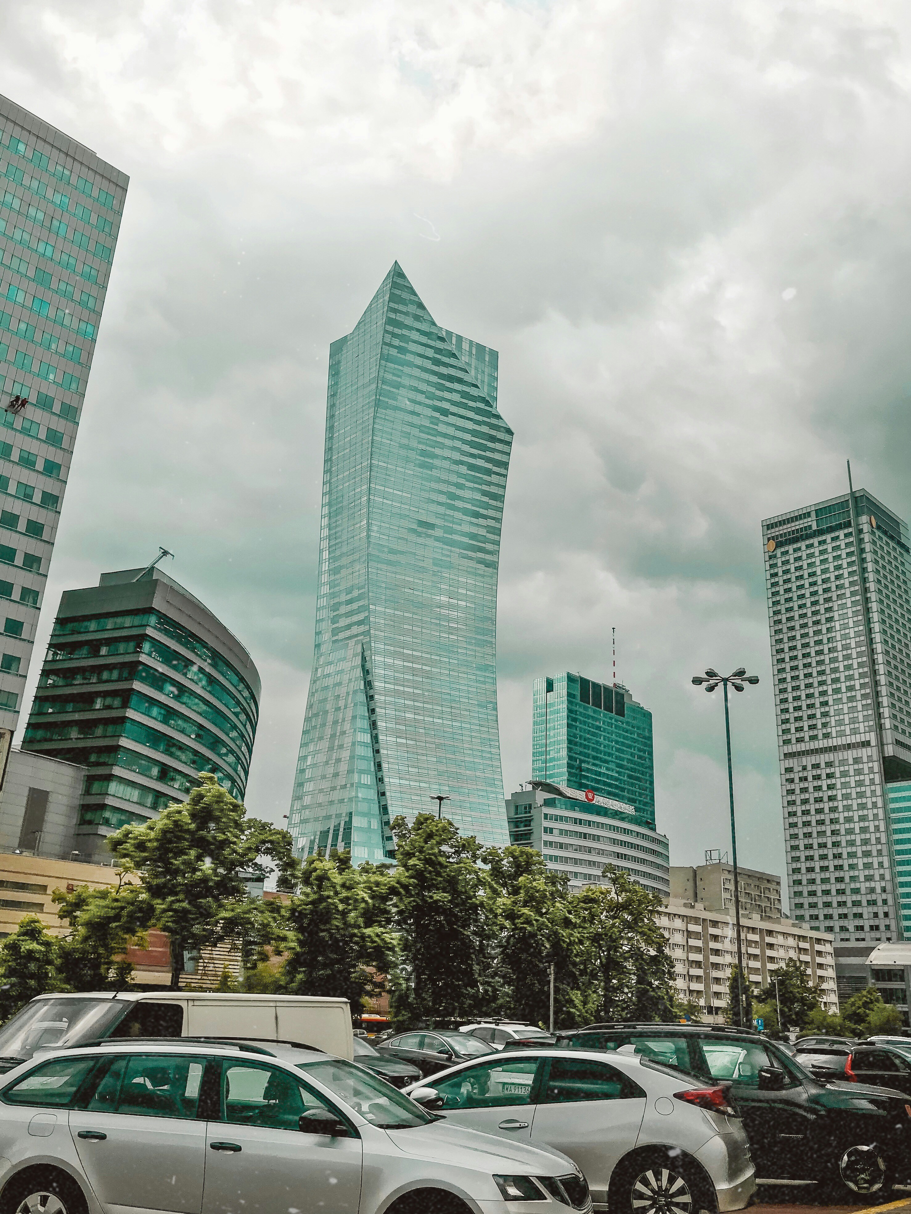vehicles in a parking lot under a cloudy sky