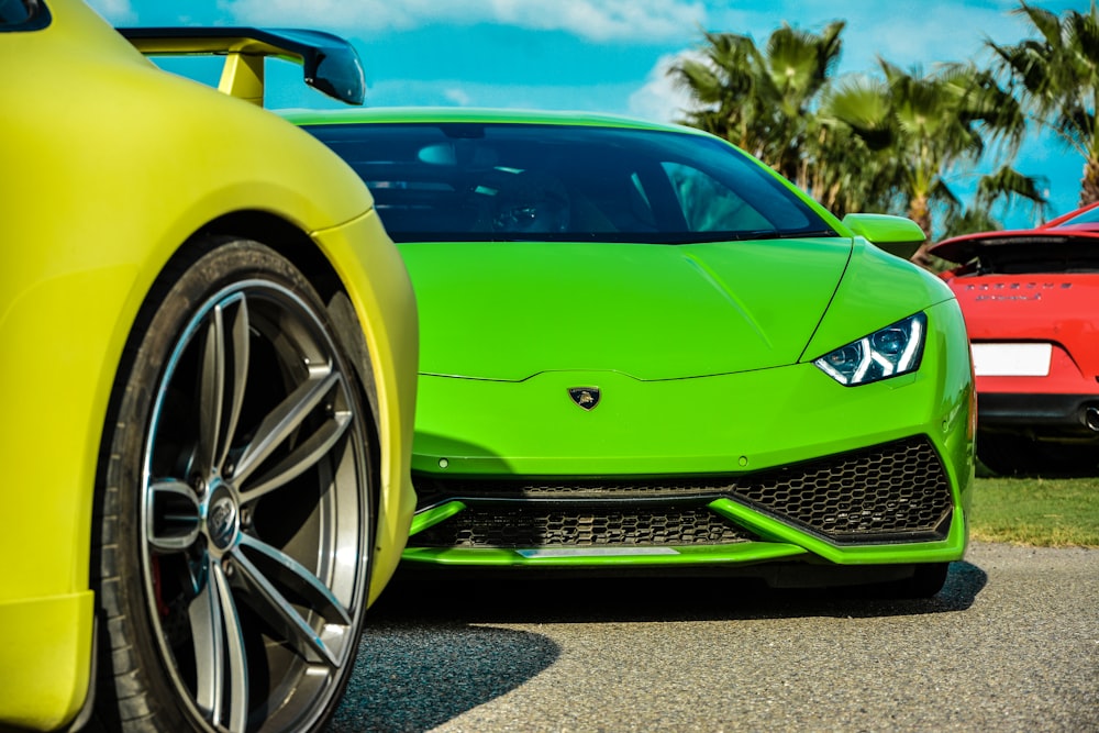 green Lamborghini sport car near another tow vehicles