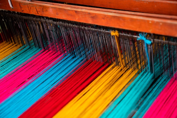 Close-up of colorful threads and weaving equipment in the factory