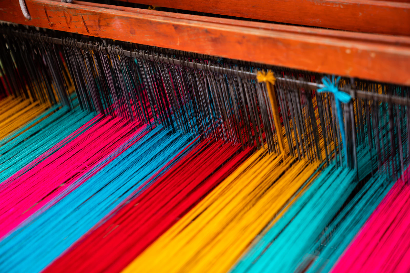 Assorted colourful textile samples showing weaving patterns
