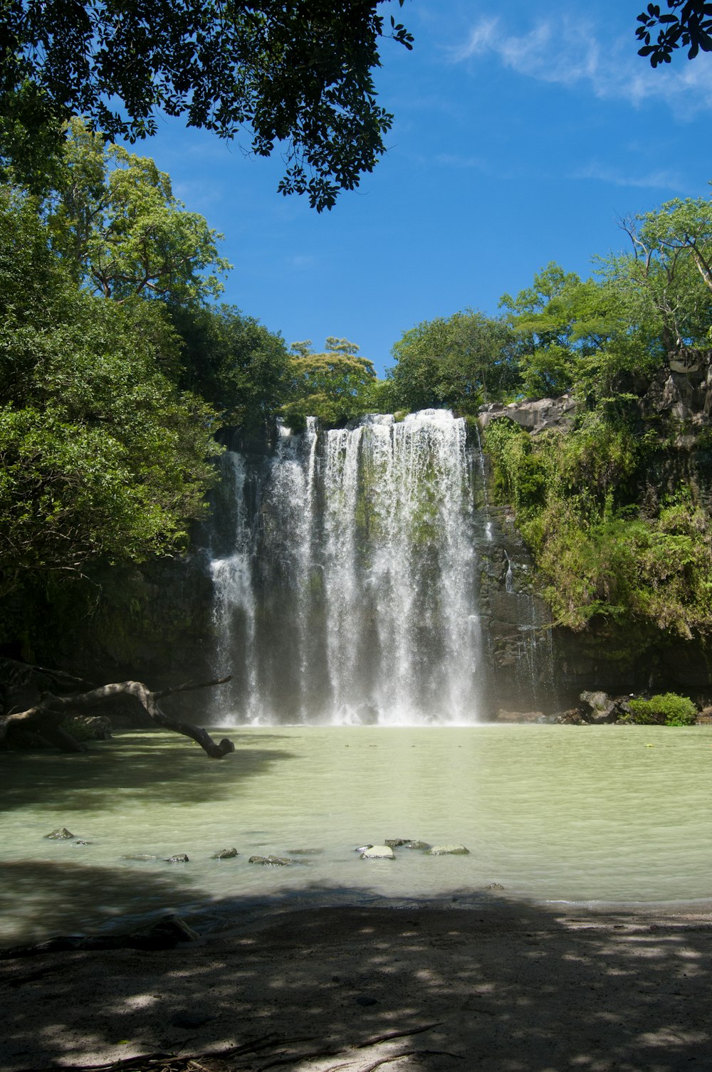 water falls on green grass field during daytime