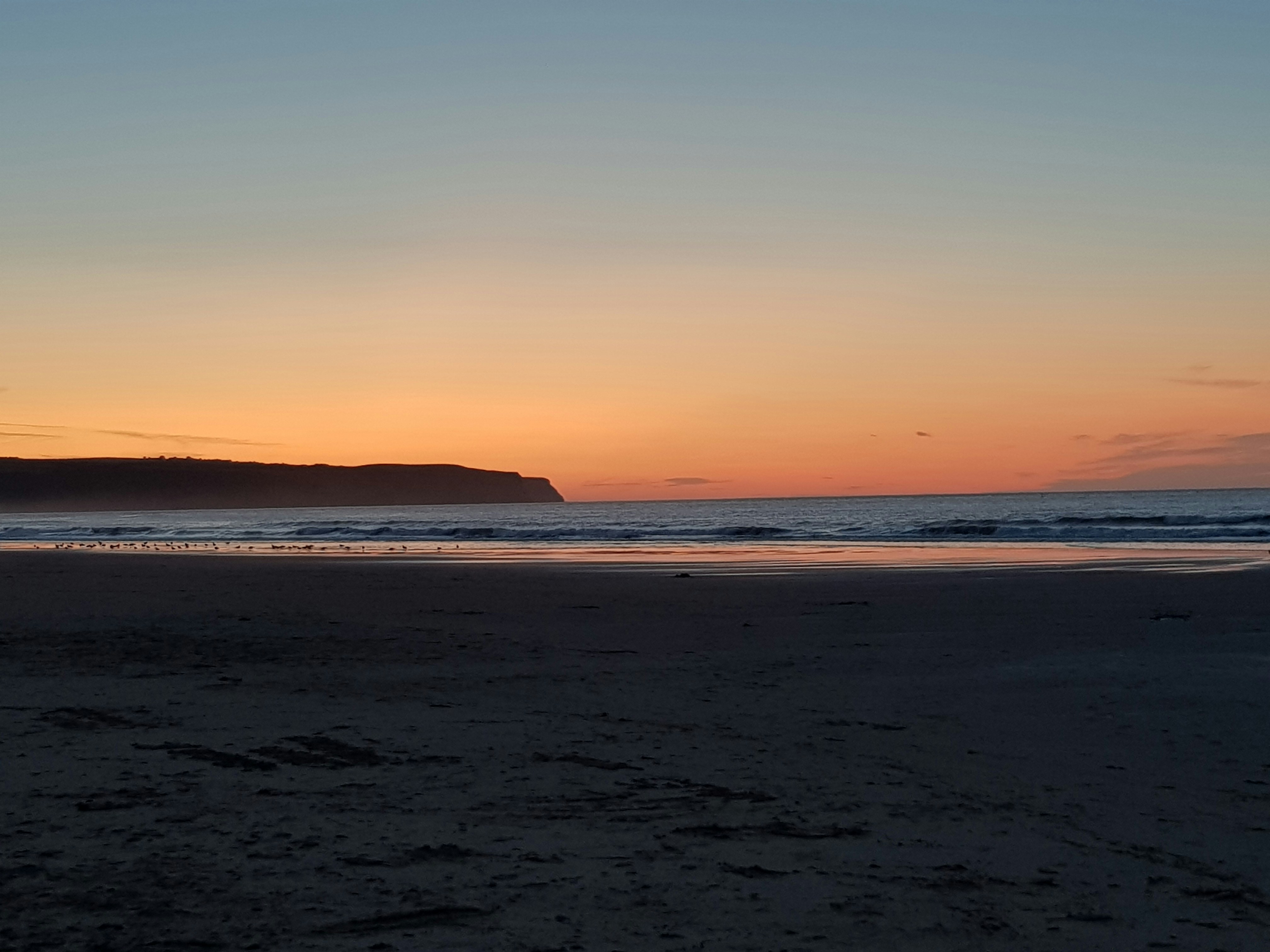 calm body of water during golden hour