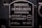 A metal plaque with the text 'Original Heidelberg Einfarben Offset oder Letterset' and measurements '46x62 cm' and '18x24½'. The background of the plaque is dark, and the text and borders are in a lighter metallic color.