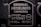 A metal plaque with the text 'Original Heidelberg Einfarben Offset oder Letterset' and measurements '46x62 cm' and '18x24½'. The background of the plaque is dark, and the text and borders are in a lighter metallic color.