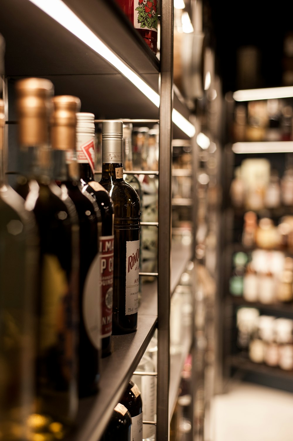 assorted wine bottles display on gray rack
