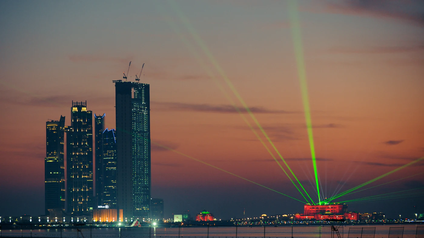A lit concrete building in Abu Dhabi during the day