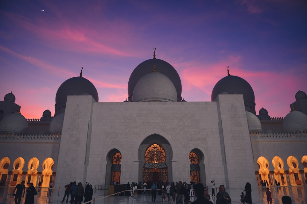 low-angle photography of a prayer temple under a purple sky