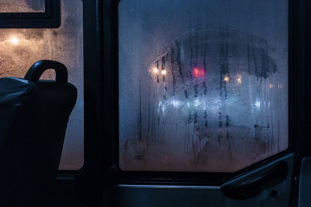 a view of a street through a window at night