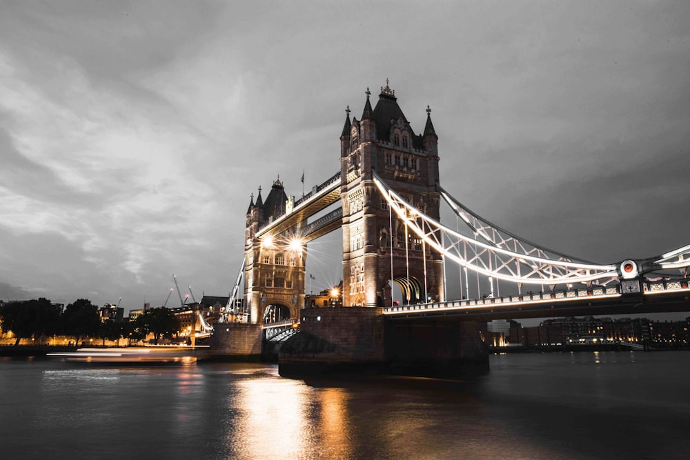 lighted bridge above calm body of water