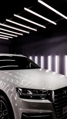 A sleek, single used car parked in a clean, open space under soft natural light.