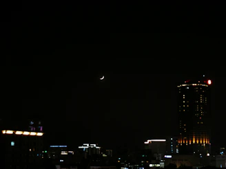 A nighttime Paris skyline with a crescent moon glowing above, hinting at the brand’s inspiration.