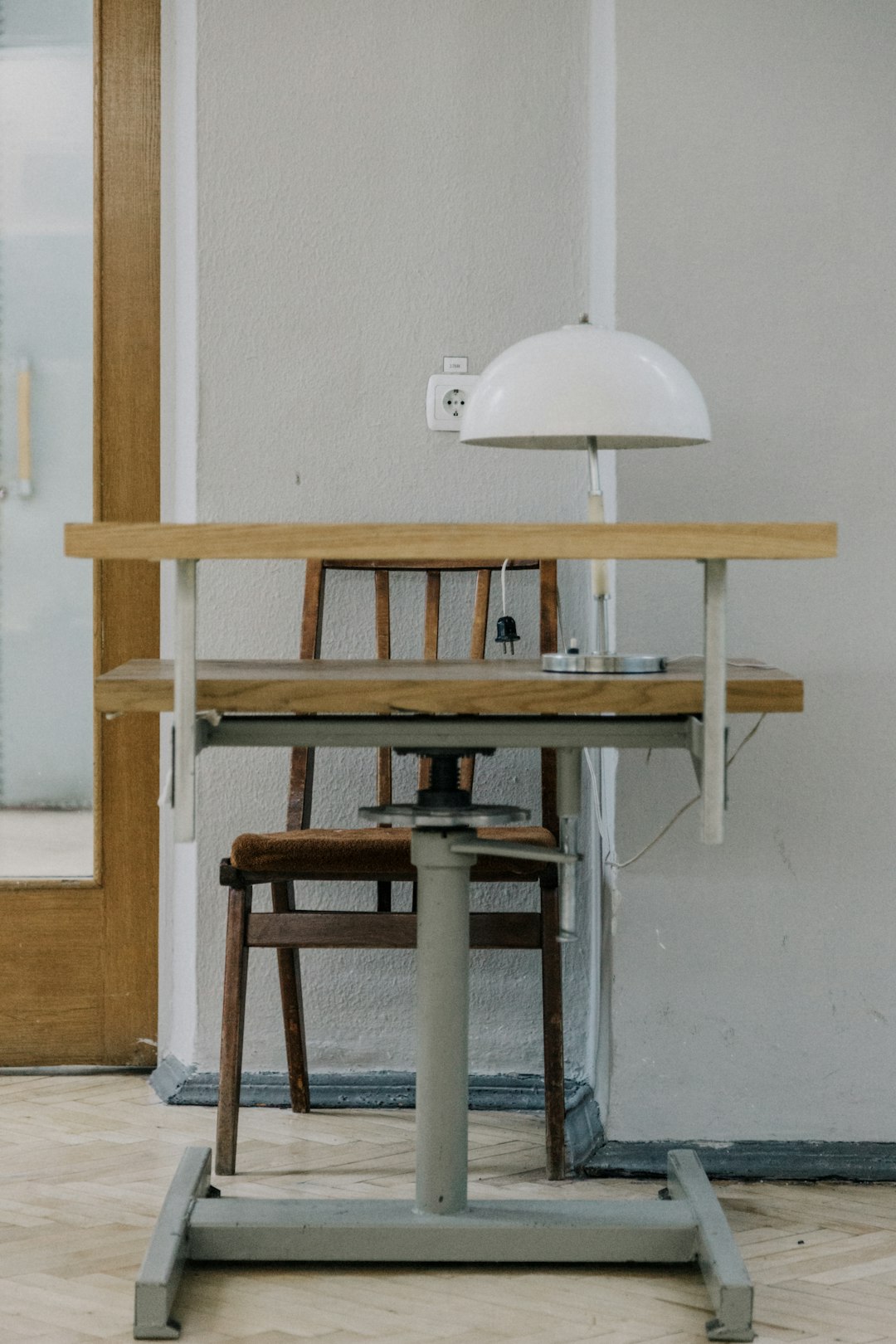table lamp on wooden table beside chair
