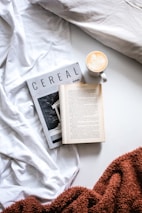 cup of coffee beside open book
