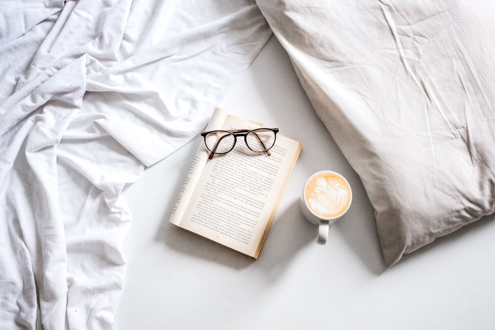 brown framed eyeglasses on book