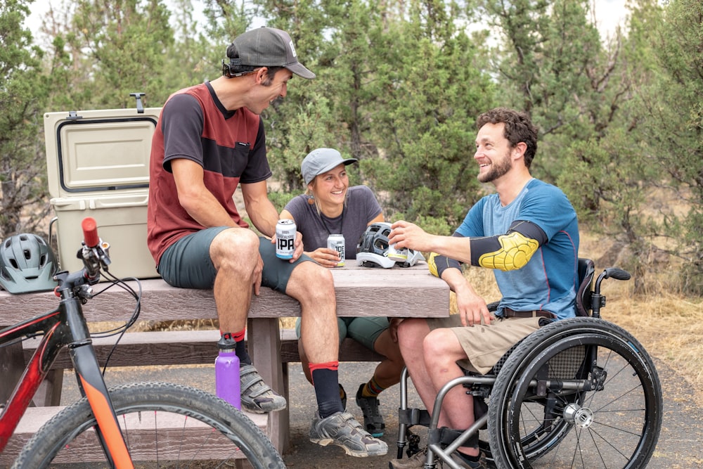 three people having conversation inside park