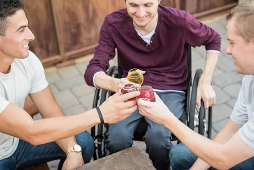 three men holding drinking glasses