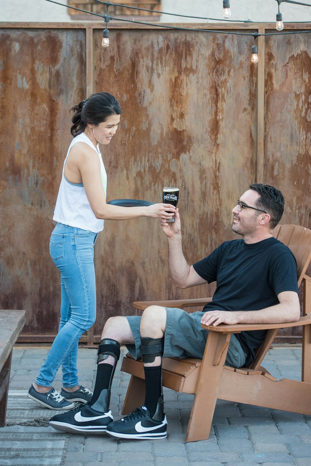 shallow focus photo of woman giving man drinking glass