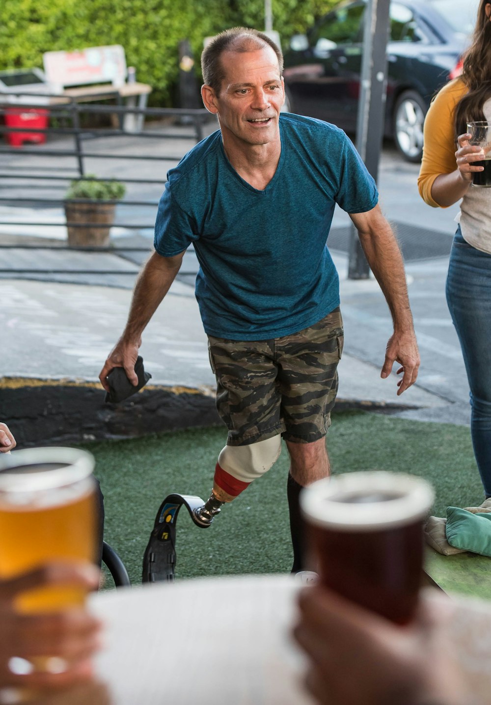 man with prosthetic leg about to throw black pack