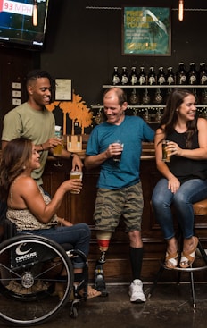 Person in a wheelchair having fun in the company of friends