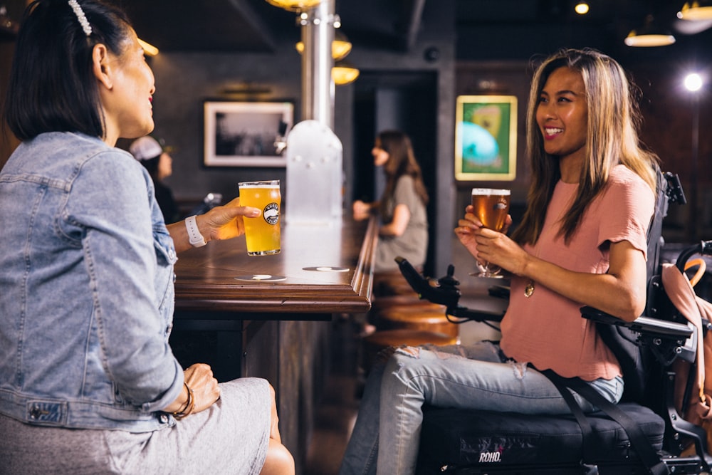 two women sitting at the table inside bar